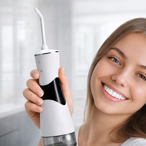 Девушка держит в руках ирригатор stl di-s01 и улыбается.